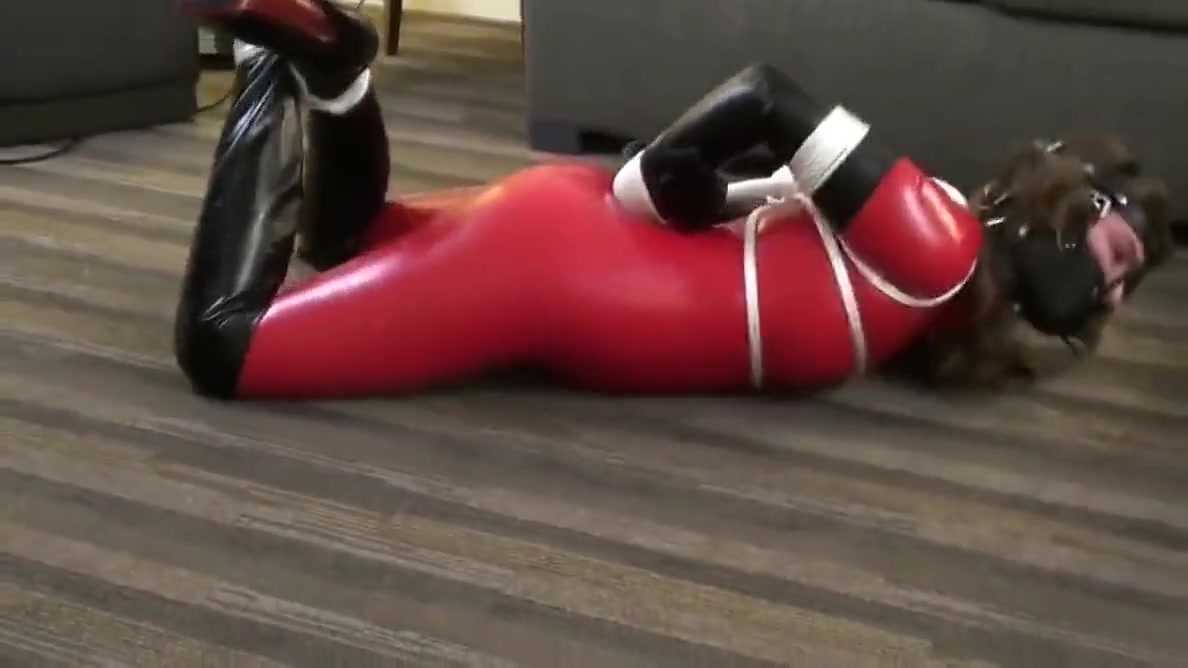 Red Latex Catsuit Girl Muzzled And Tied Up
